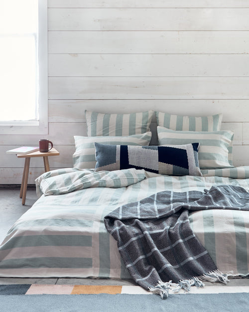 Ethically handwoven MINNA duvet cover, pillowcases, shams, and decorative throw pillows and throw blankets in light blue, sky, dusk, indigo, colors.